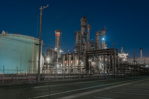 a factory with a lot of pipes and lights