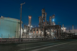 a factory with a lot of pipes and lights