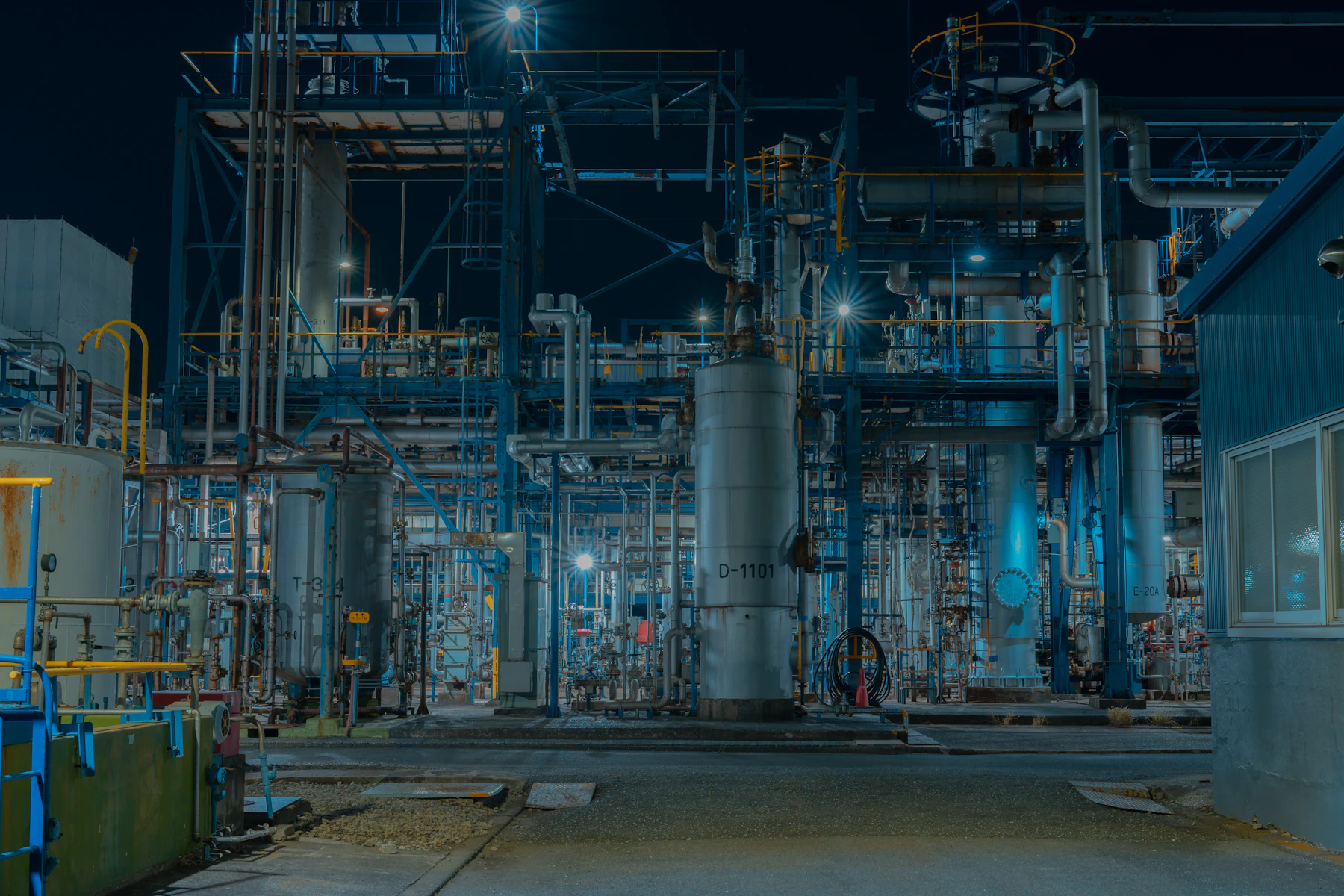 Industrial plant pipework at night