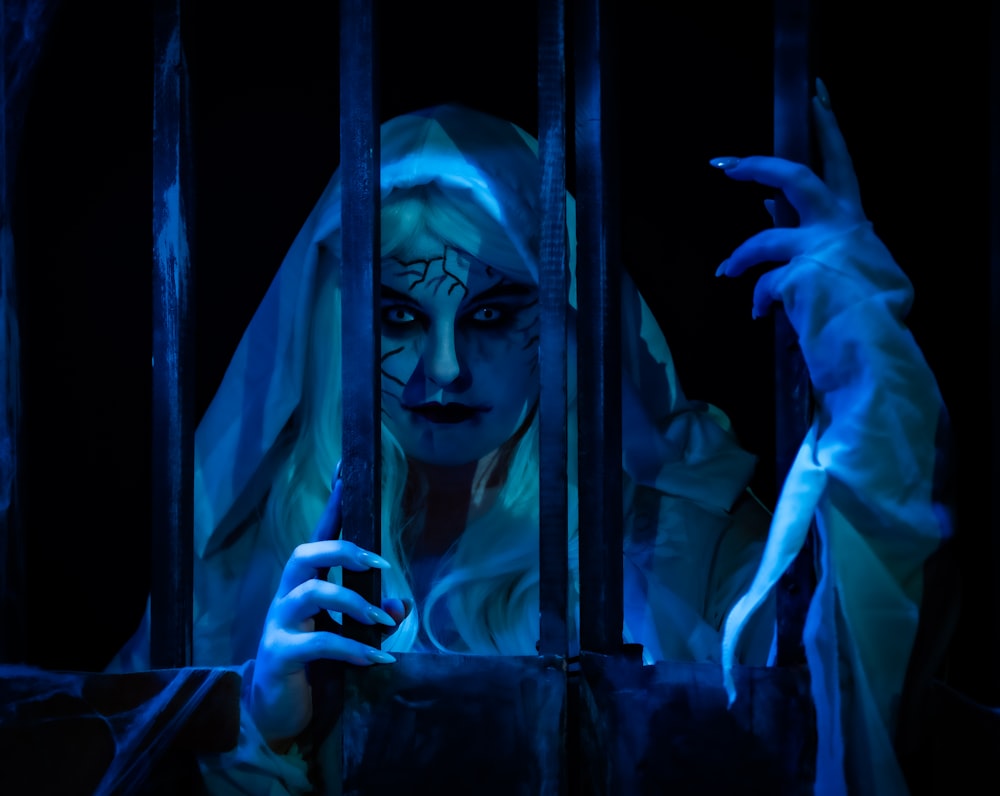 a woman dressed as a ghost holding a cell phone