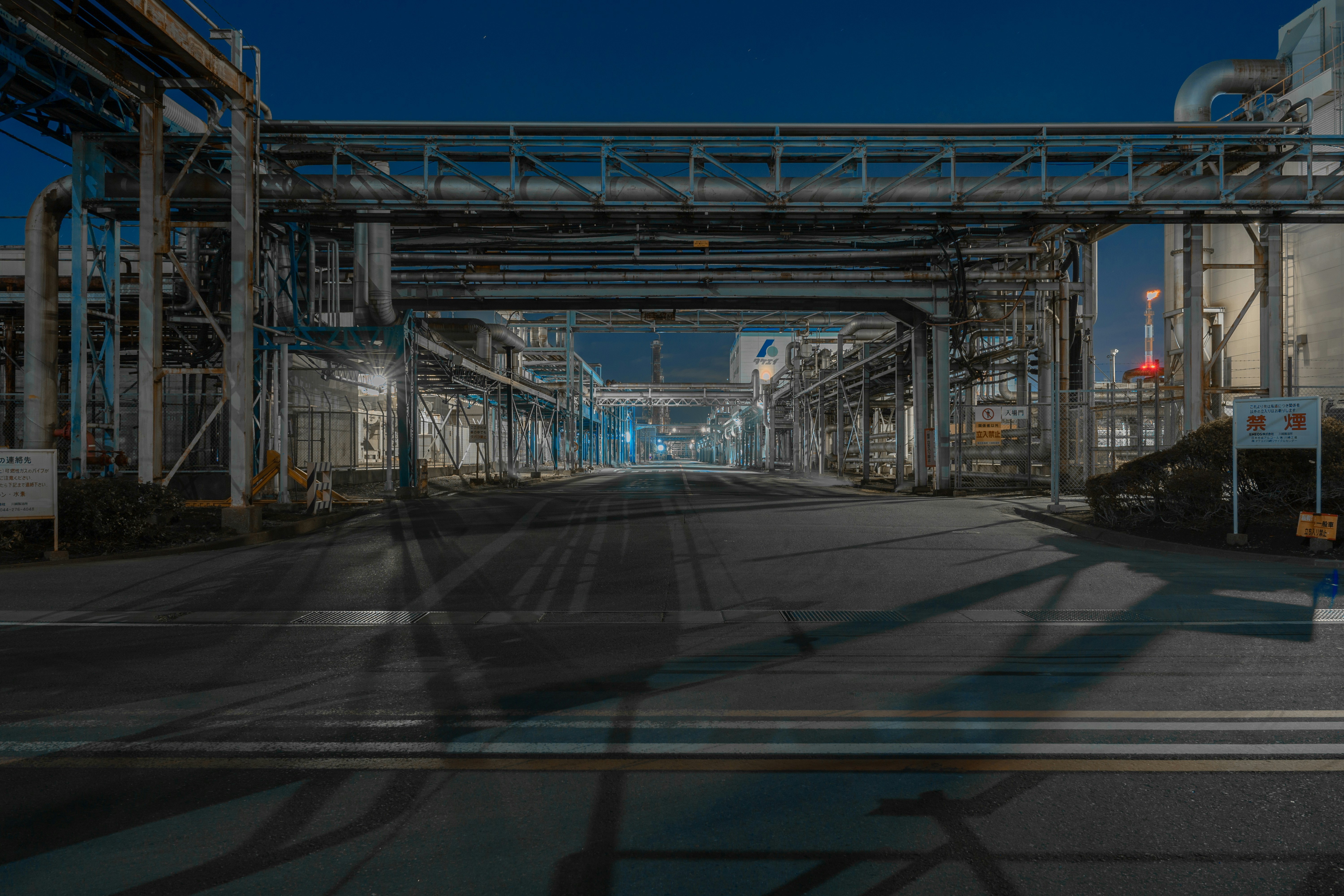 an empty street under a bridge at night