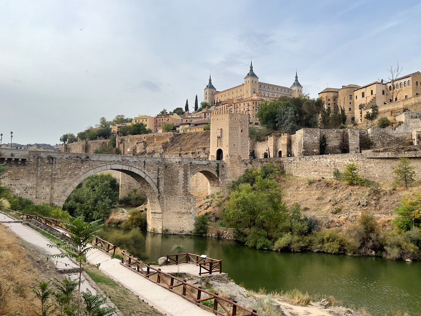 The Alcántara bridge over the Tagus, with the Alcázar above the town — Toledo, Spain