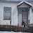 Happy woman beside a warm-toned wood-look composite garage door in a snowy driveway.