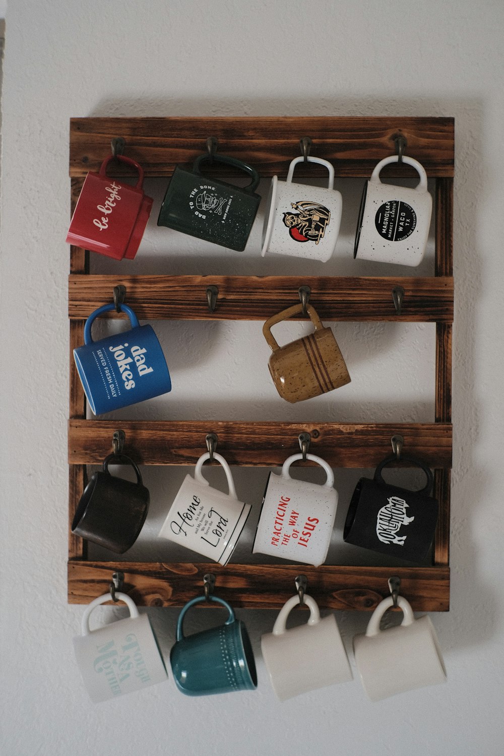 a wooden rack with coffee mugs hanging on it