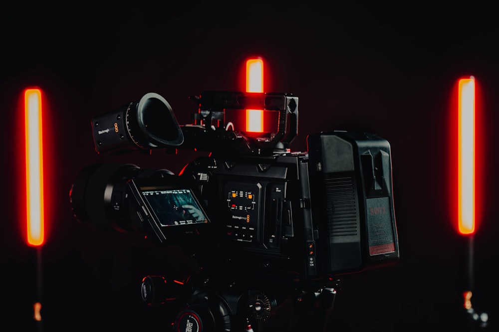 a video camera with red lights on a black background