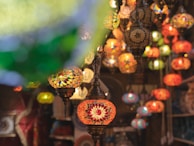 A colorful assortment of handcrafted Moroccan lanterns hanging in a marketplace.
