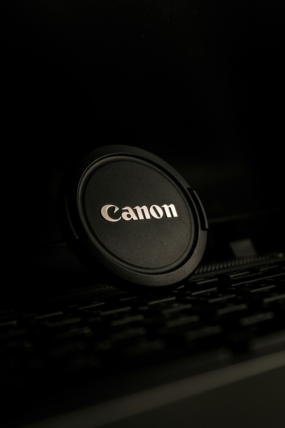 a close up of a camera lens cap on a keyboard