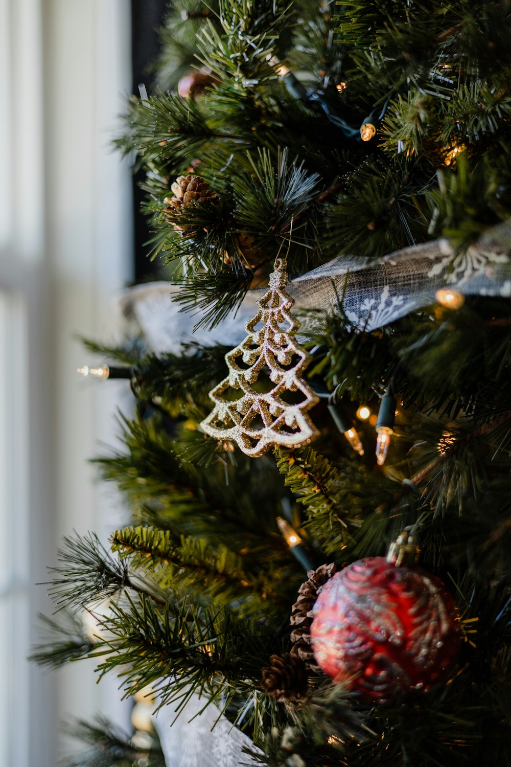 a close up of a christmas tree with ornaments