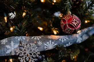 Vibrant seasonal 3D printed ornaments and decor pieces hanging on a decorative branch.