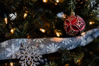 Vibrant seasonal 3D printed ornaments and decor pieces hanging on a decorative branch.