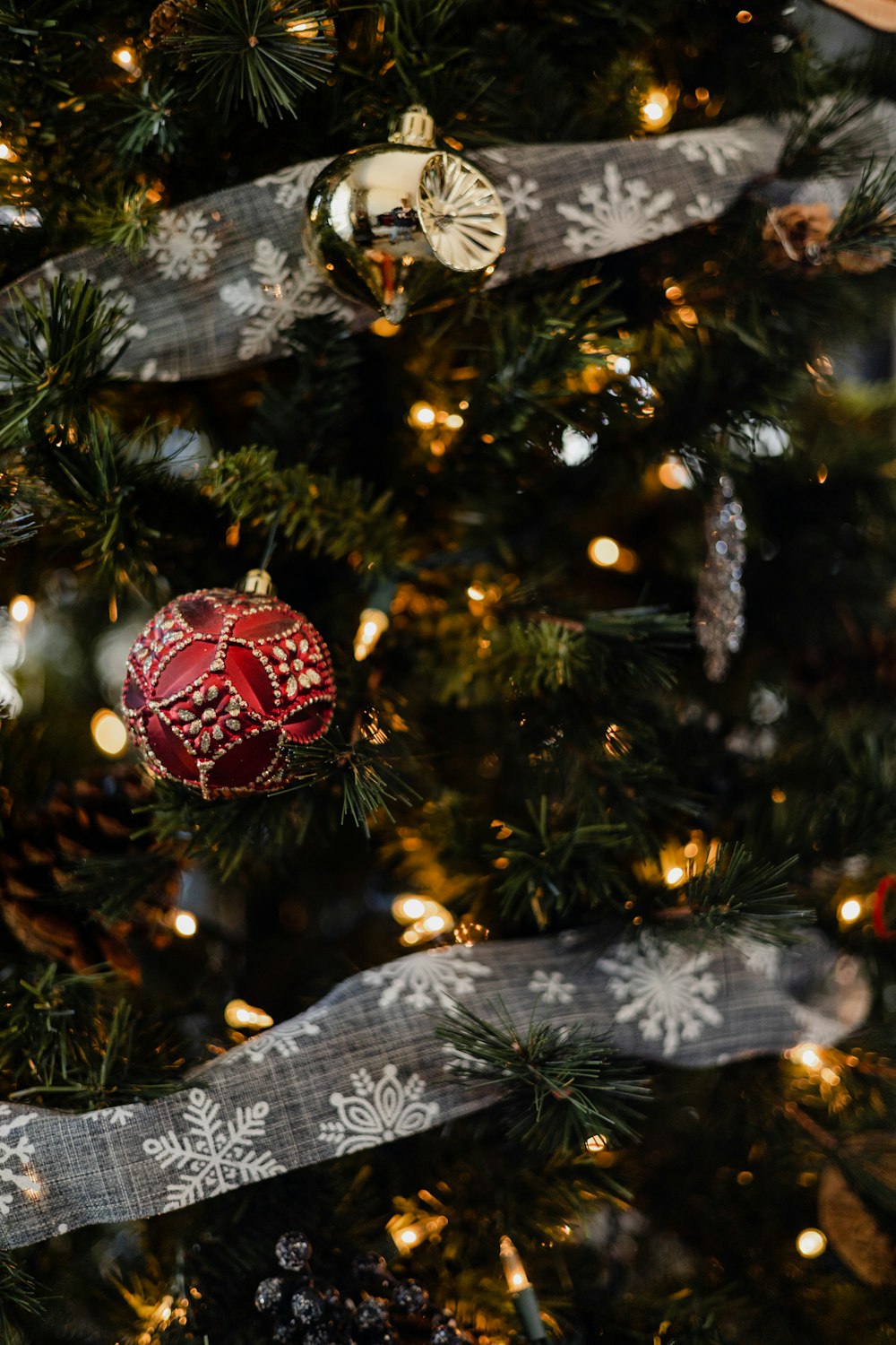 a close up of a christmas tree with ornaments on it