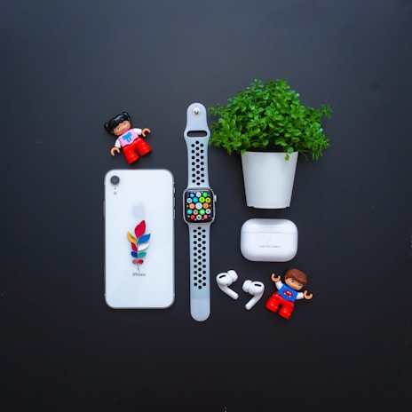 Flat lay of Spiritel Gadget earphones alongside a smartphone and phone case.