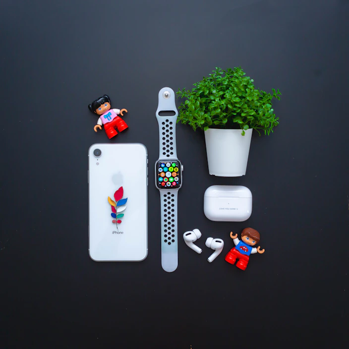 A neatly arranged flat lay of colorful phone and charging accessories on a clean white surface.