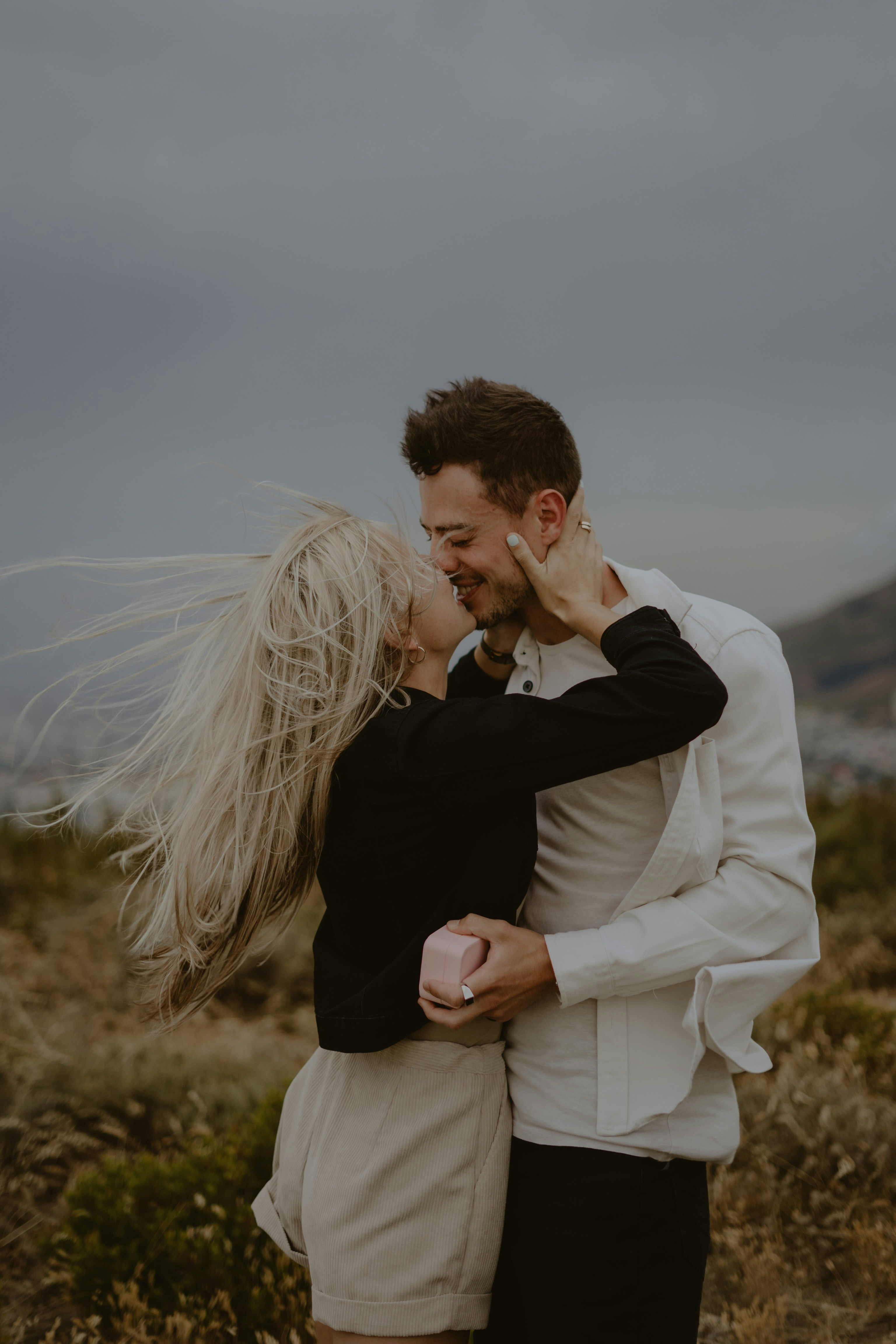 a man and a woman hugging in a field