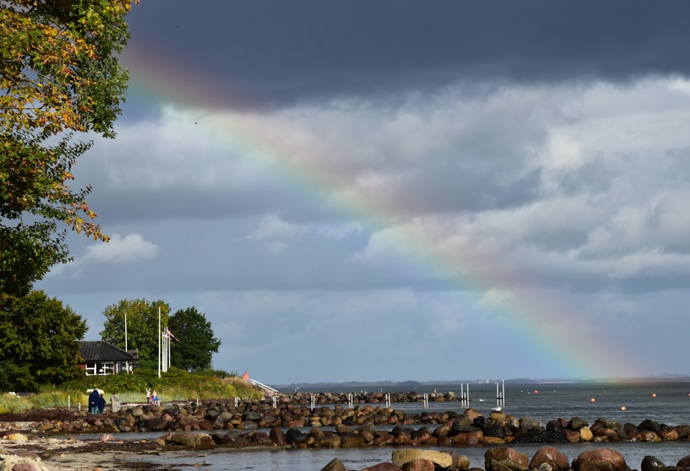 a rainbow in the sky over a body of water