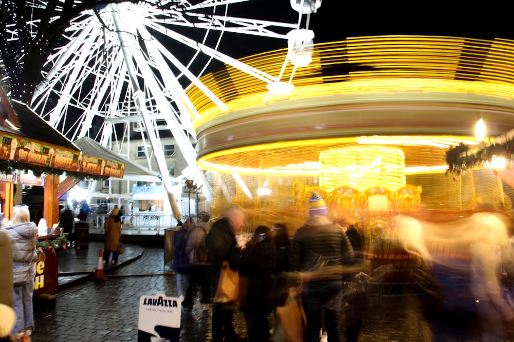 a blurry photo of a carnival ride at night