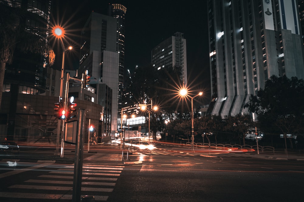 a city street at night with traffic lights