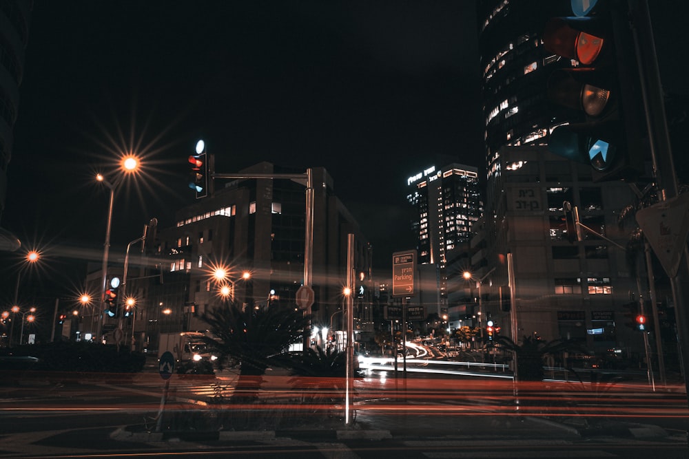 a city street at night with traffic lights