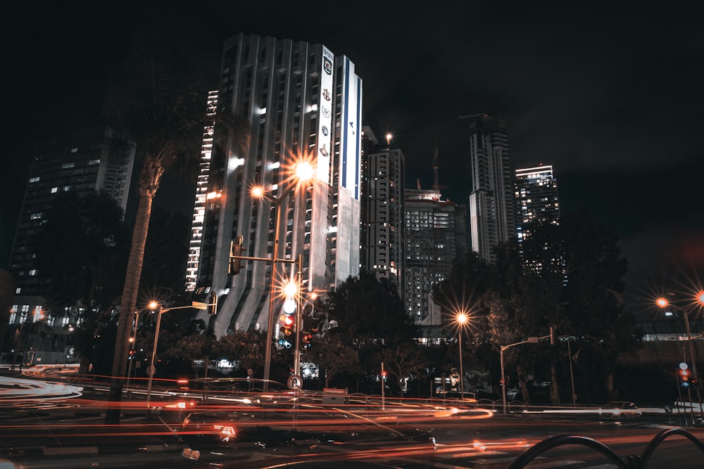 a city at night with street lights and tall buildings