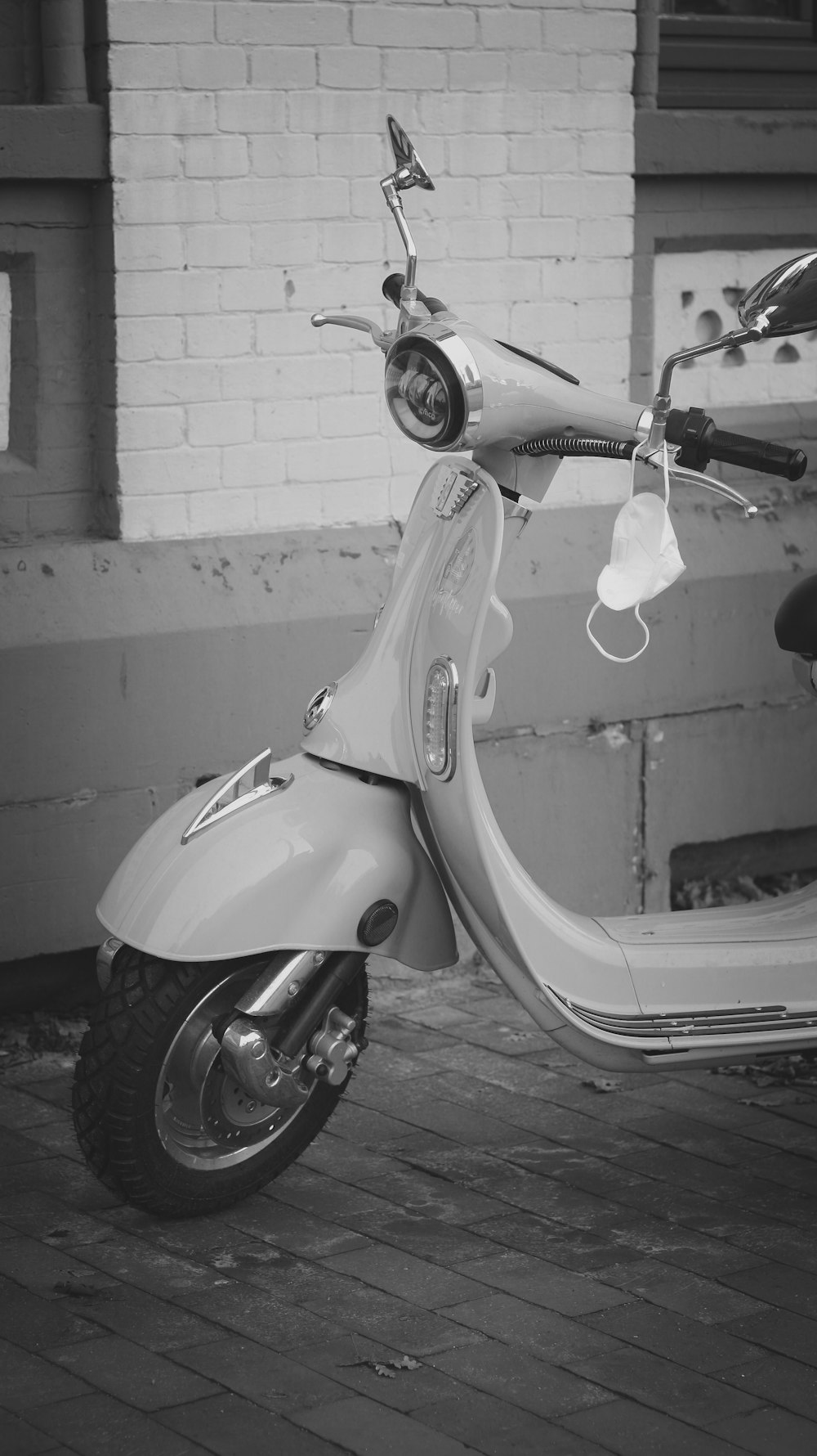 a scooter parked in front of a brick building