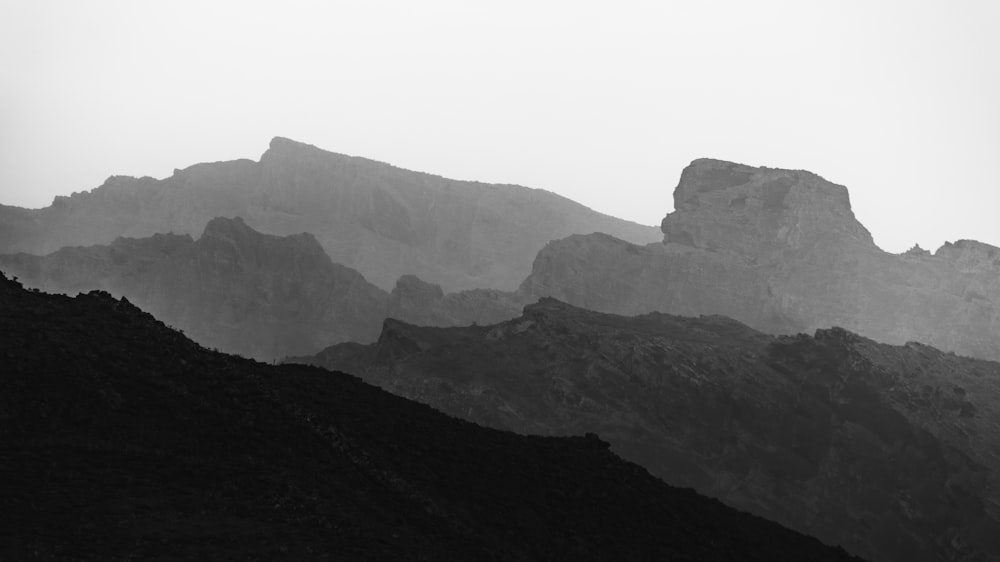 a black and white photo of a mountain range