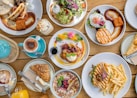 a table topped with lots of plates of food