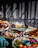 A vibrant spread of colorful dishes beautifully arranged on a rustic wooden table at a lively birthday celebration.