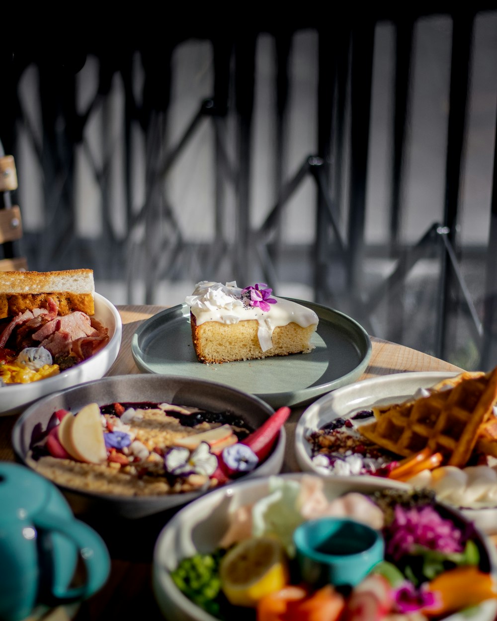 a table topped with lots of plates of food