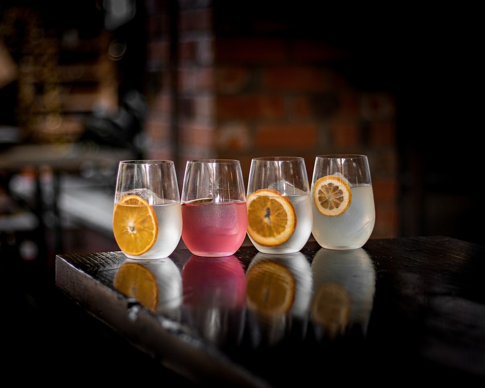 a row of wine glasses filled with different types of wine