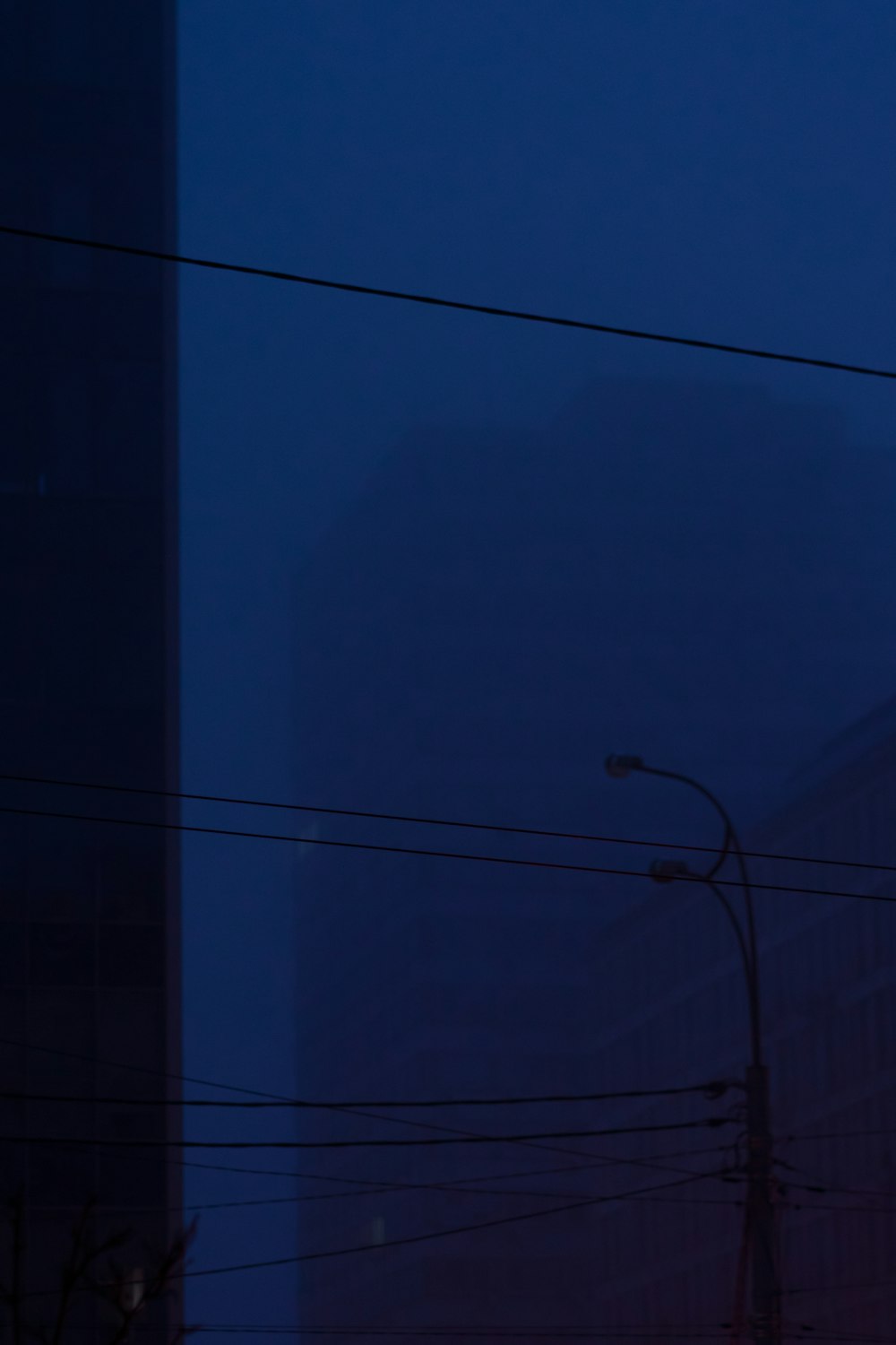 a traffic light on a street next to a tall building