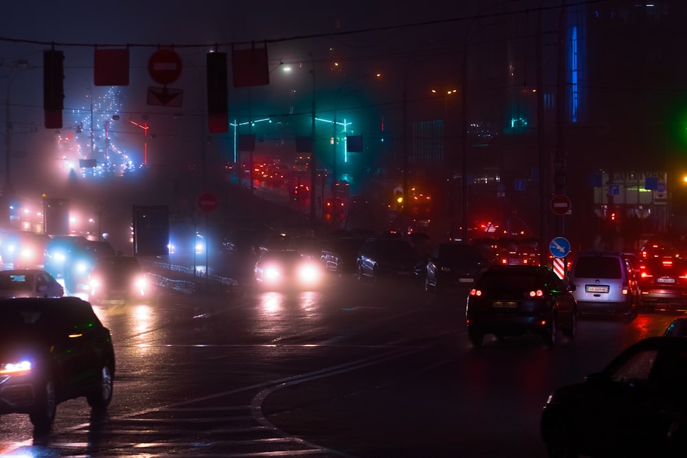 a city street filled with lots of traffic at night