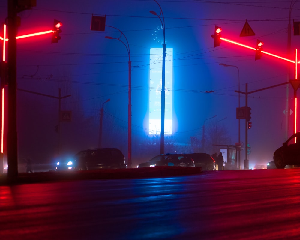 a street filled with traffic next to traffic lights