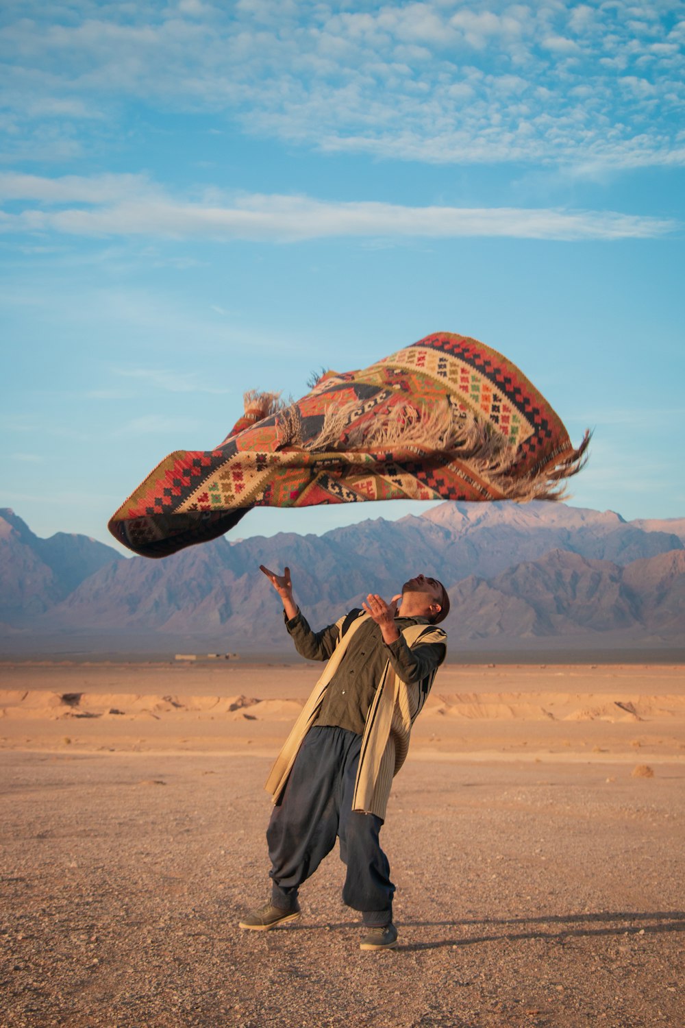 a man is flying a kite in the desert