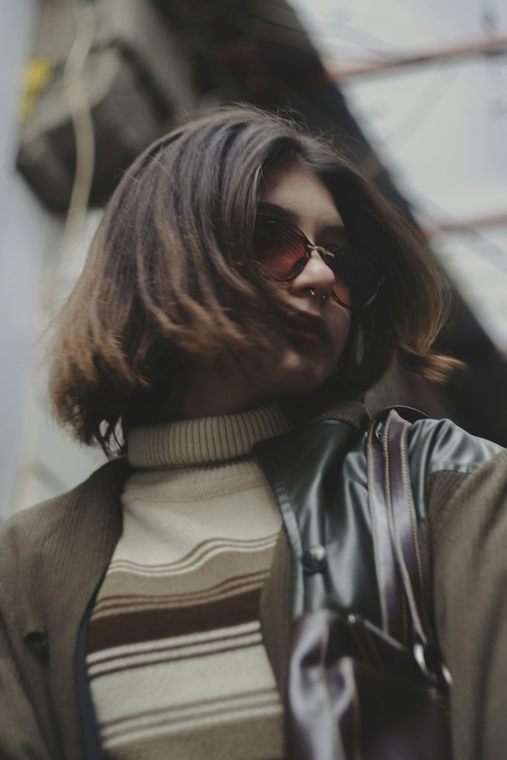 a woman in a turtle neck sweater and sunglasses