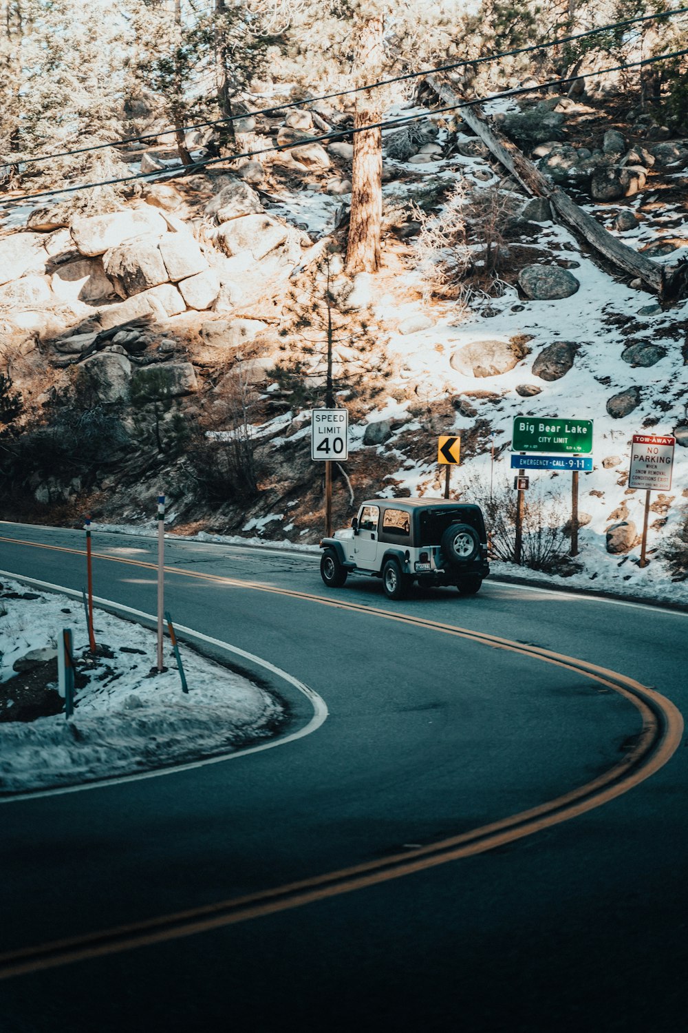 a truck driving down a curvy road in the mountains