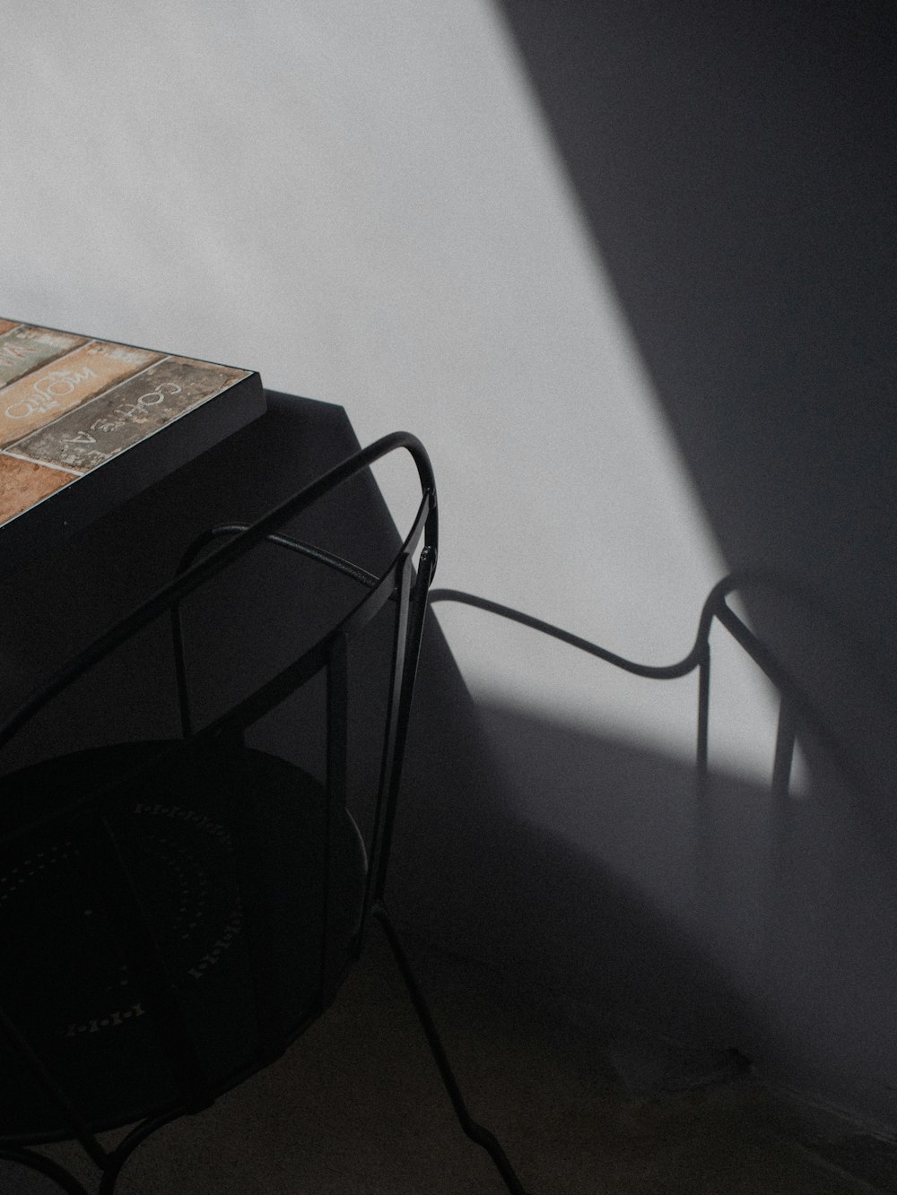 a table with a clock on top of it next to a wall