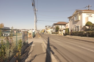 Modern residential houses lined up on a quiet suburban street.