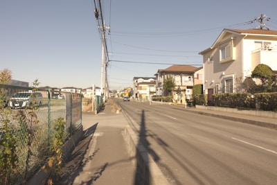 Modern residential houses lined up on a quiet suburban street.