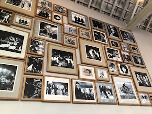 a wall full of black and white photographs