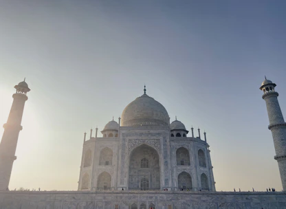 A panoramic view of the Mausoleum of Khoja Ahmed Yasawi bathed in warm sunset light.
