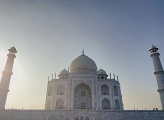 A panoramic view of the Mausoleum of Khoja Ahmed Yasawi bathed in warm sunset light, highlighting its intricate architecture.