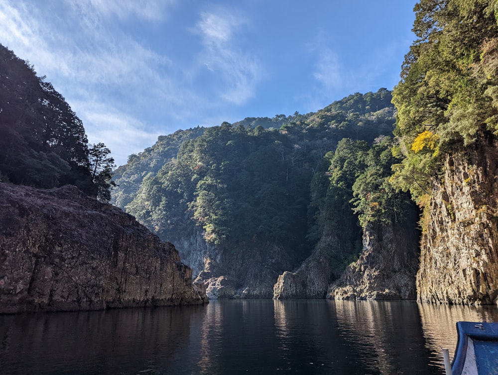 a boat is in the water near a mountain