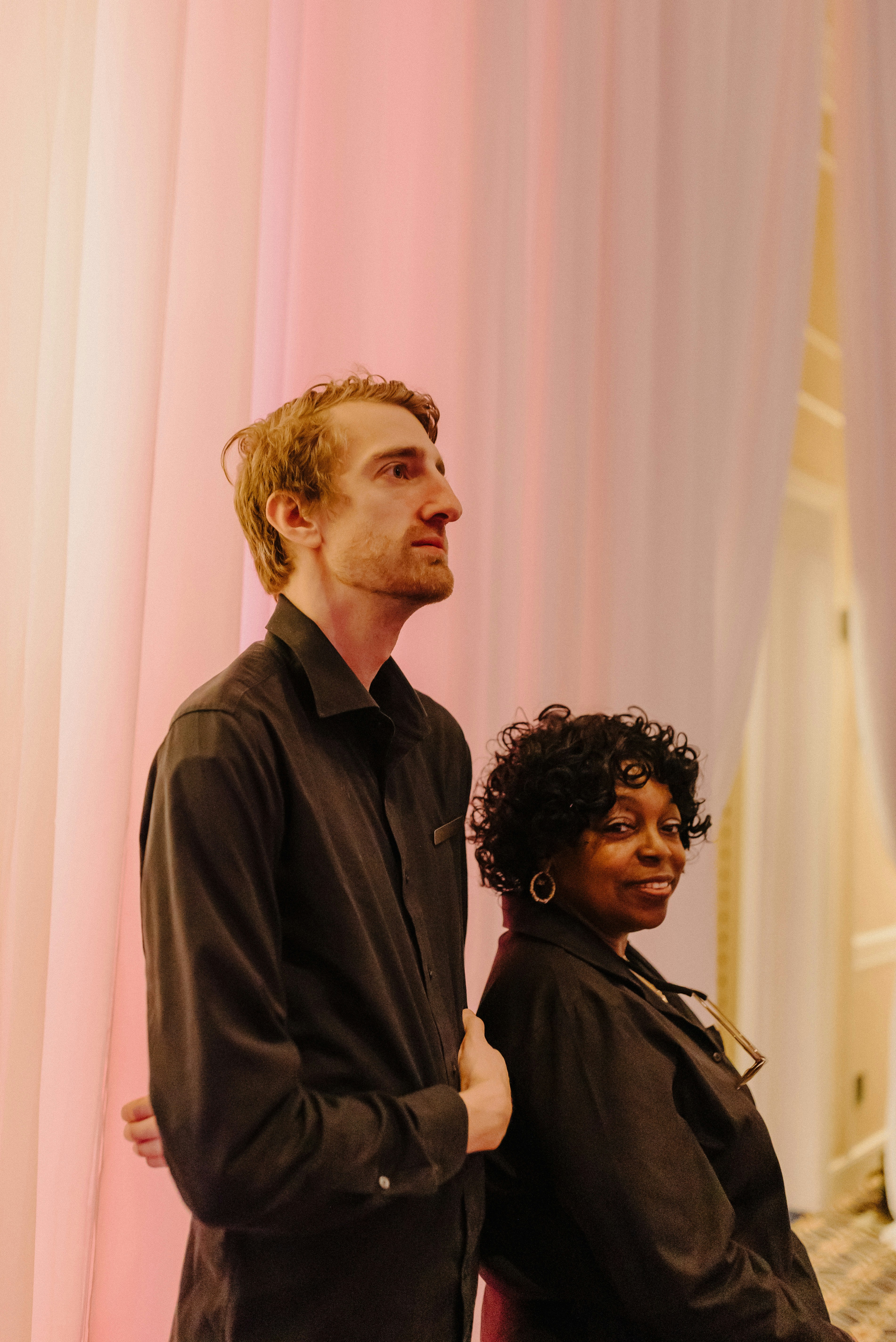 A man and a woman standing next to each other photo – Free Coat Image ...