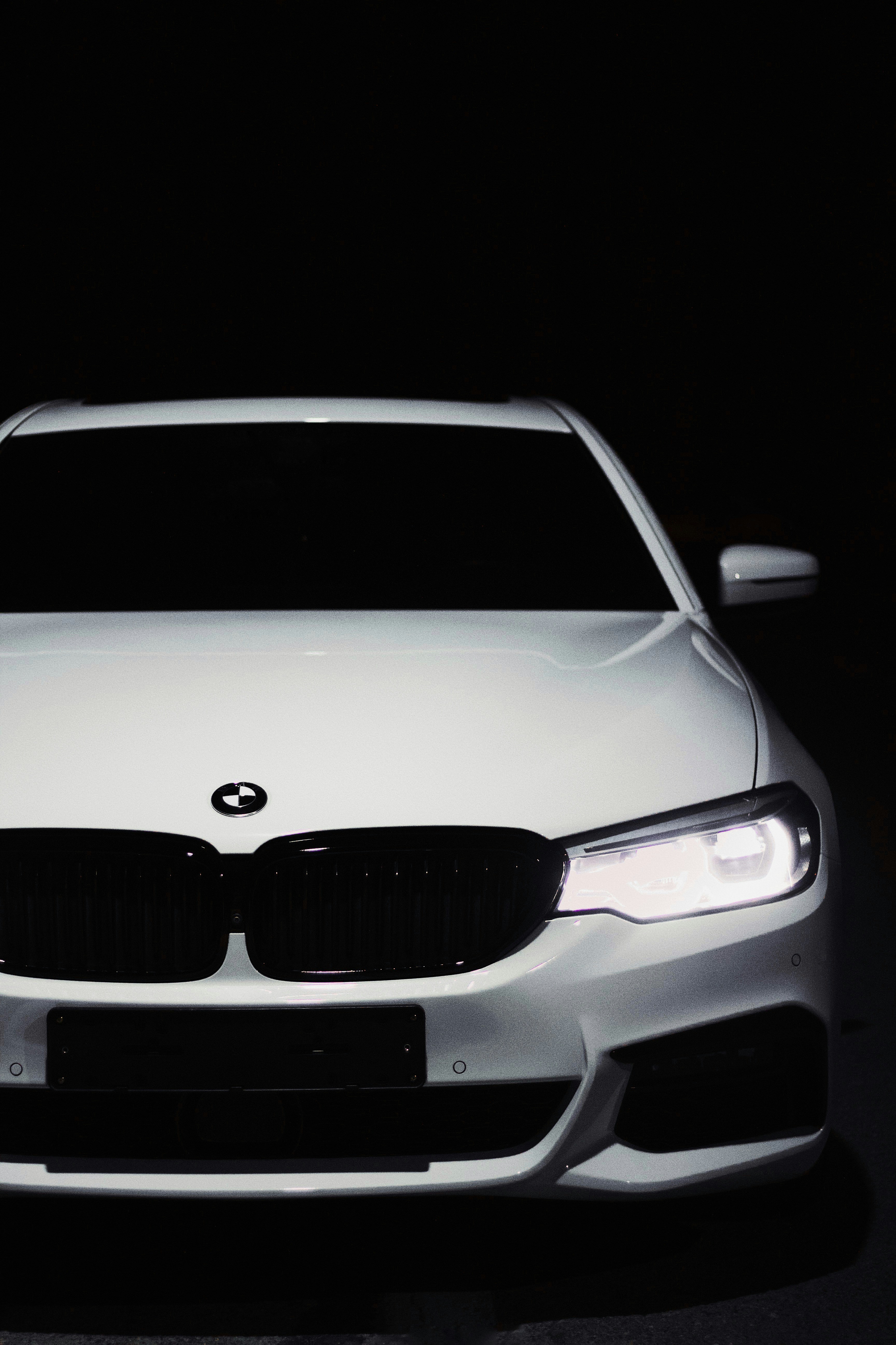 a white car is parked in the dark