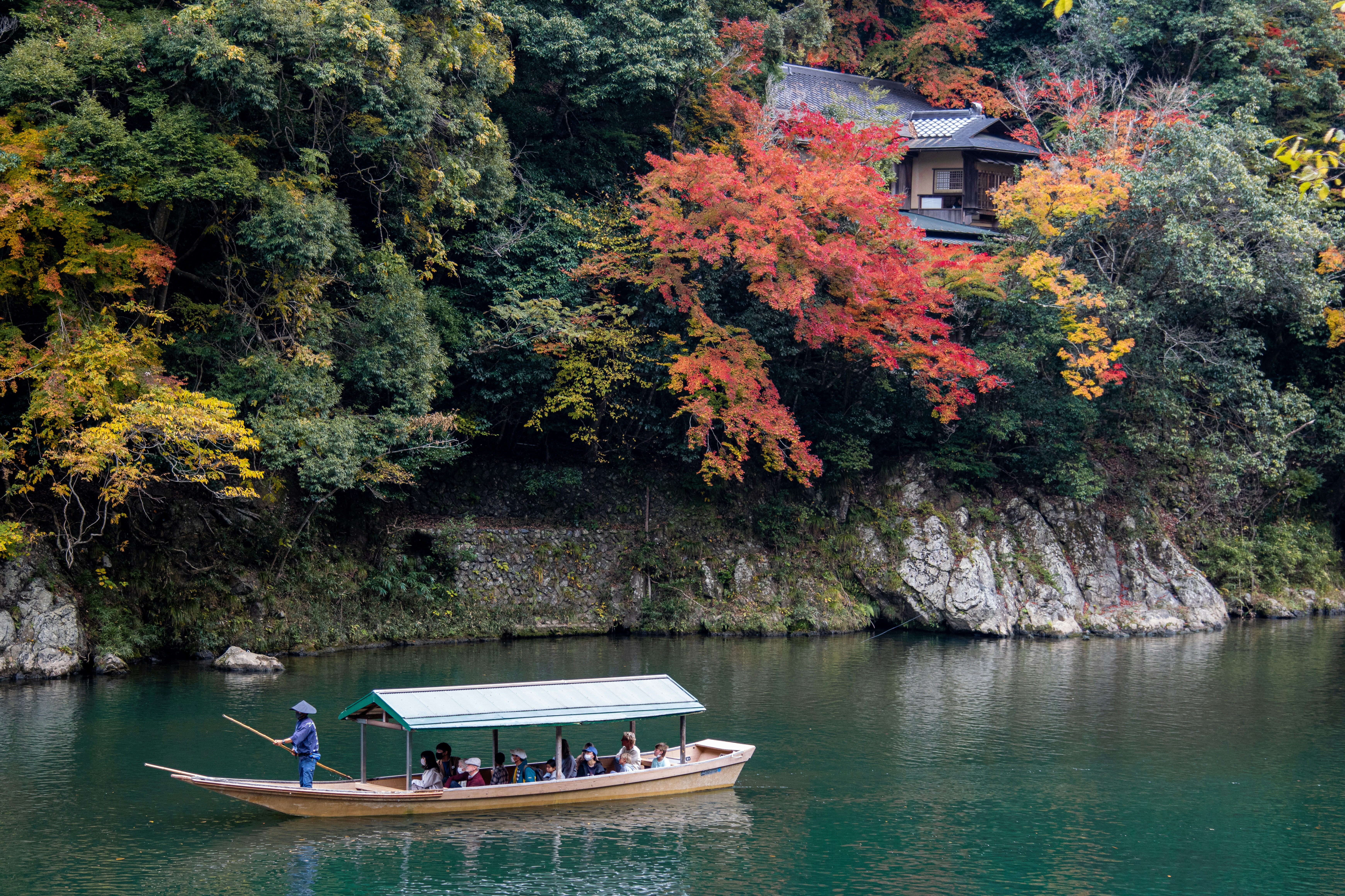 a boat filled with people on top of a lake