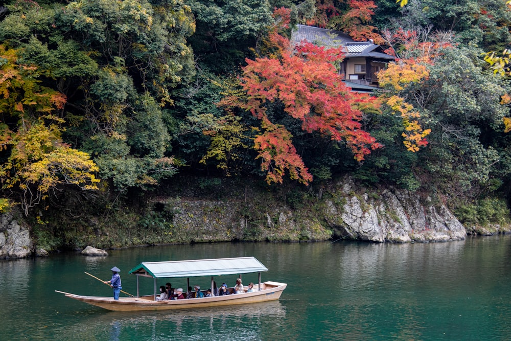 a boat filled with people on top of a lake