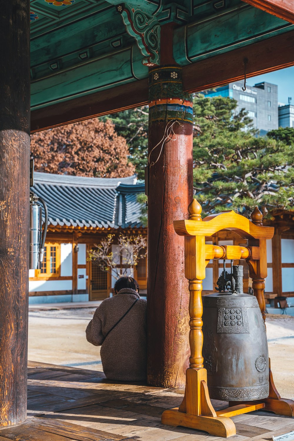 a large bell sitting under a wooden structure