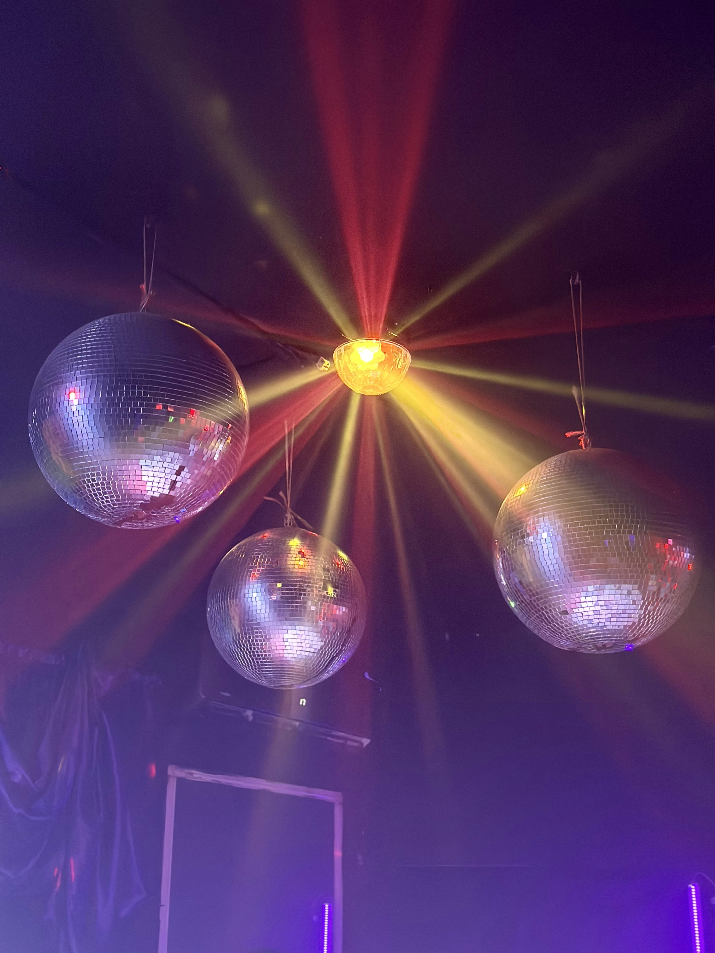 A group of disco balls hanging from a ceiling photo Free Image on
