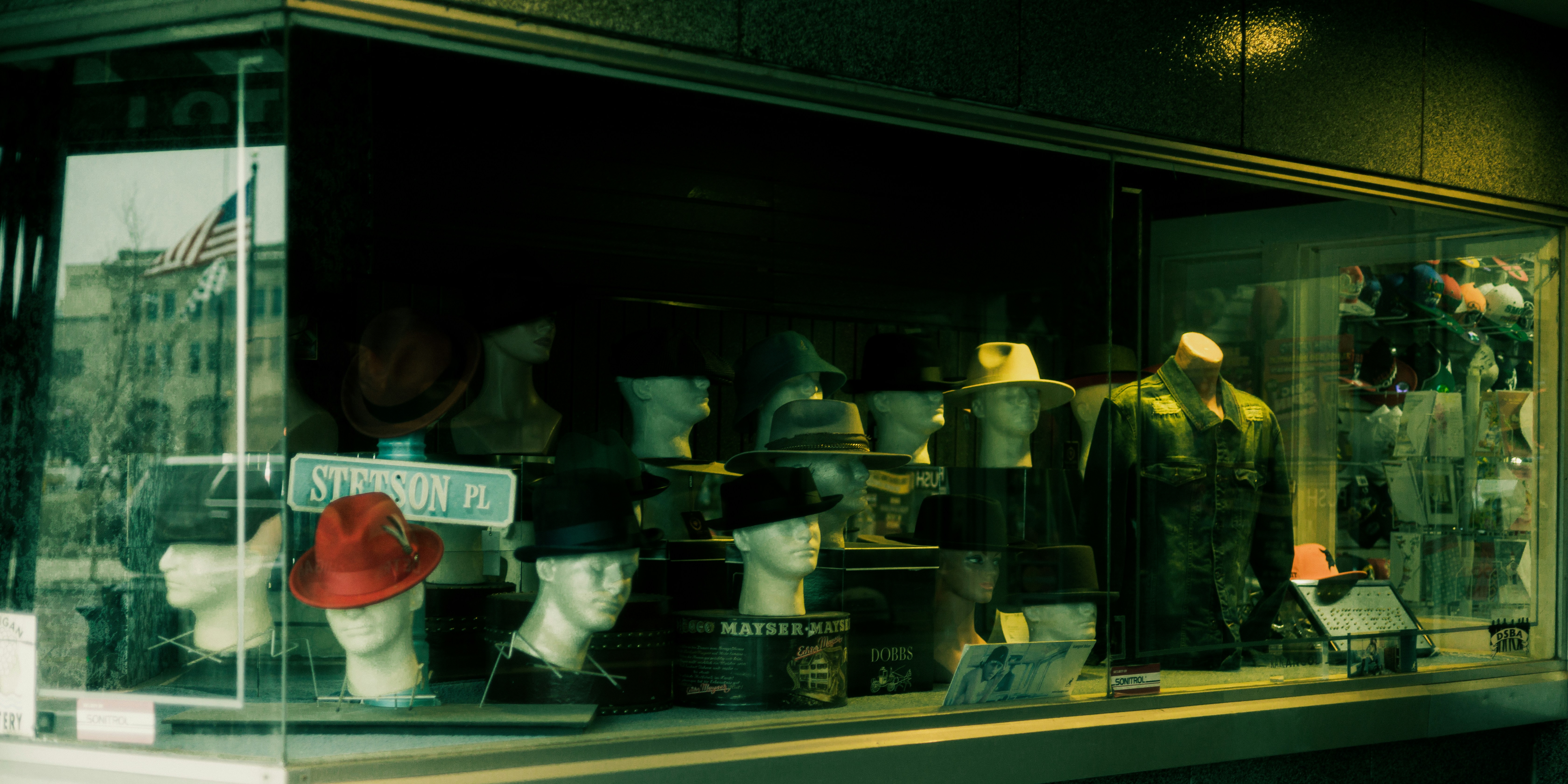 a window display of hats and other items
