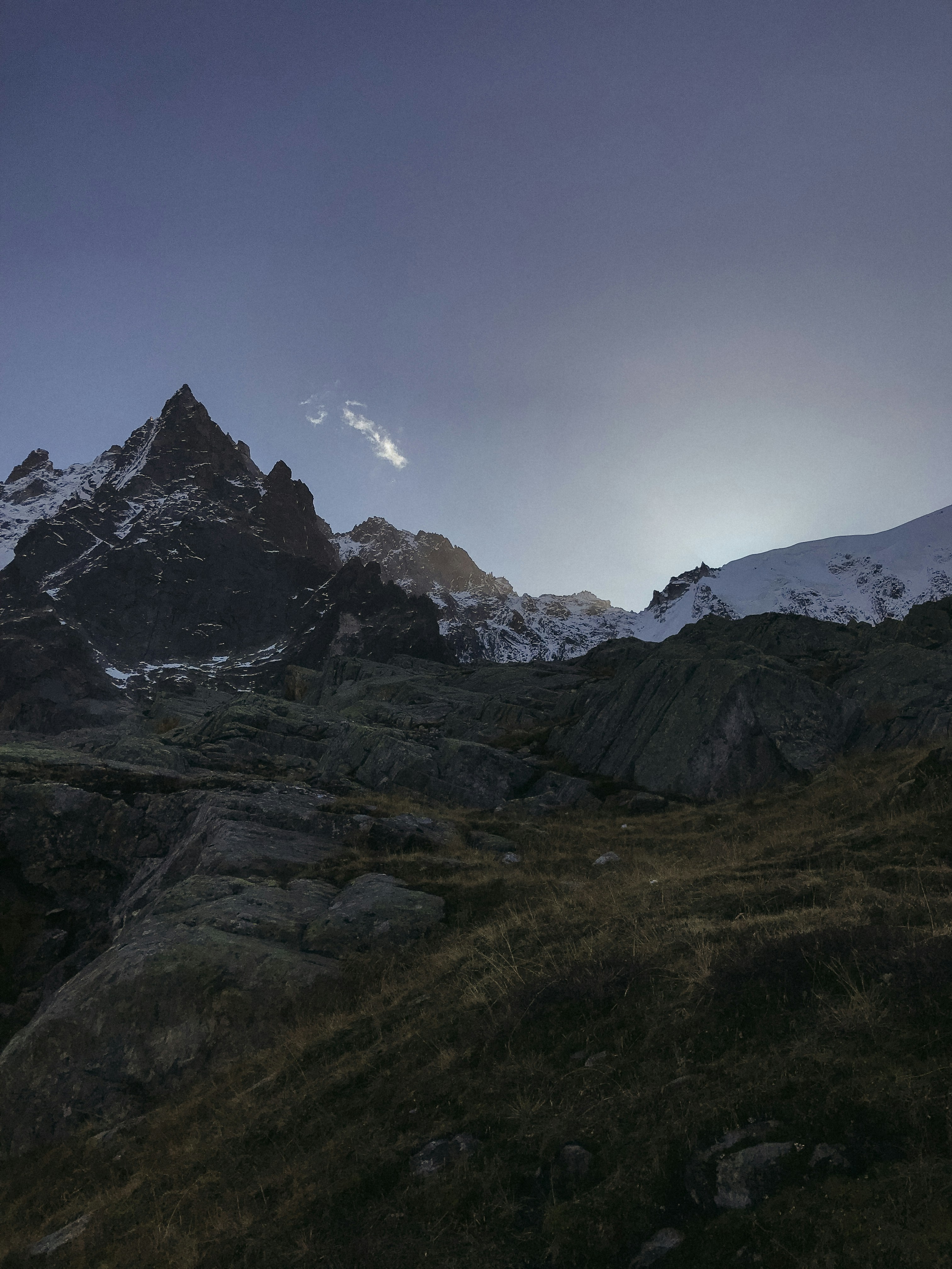 a mountain range with snow covered mountains in the background